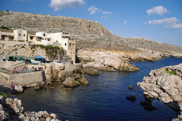 Some people swimming at Għar Lapsi